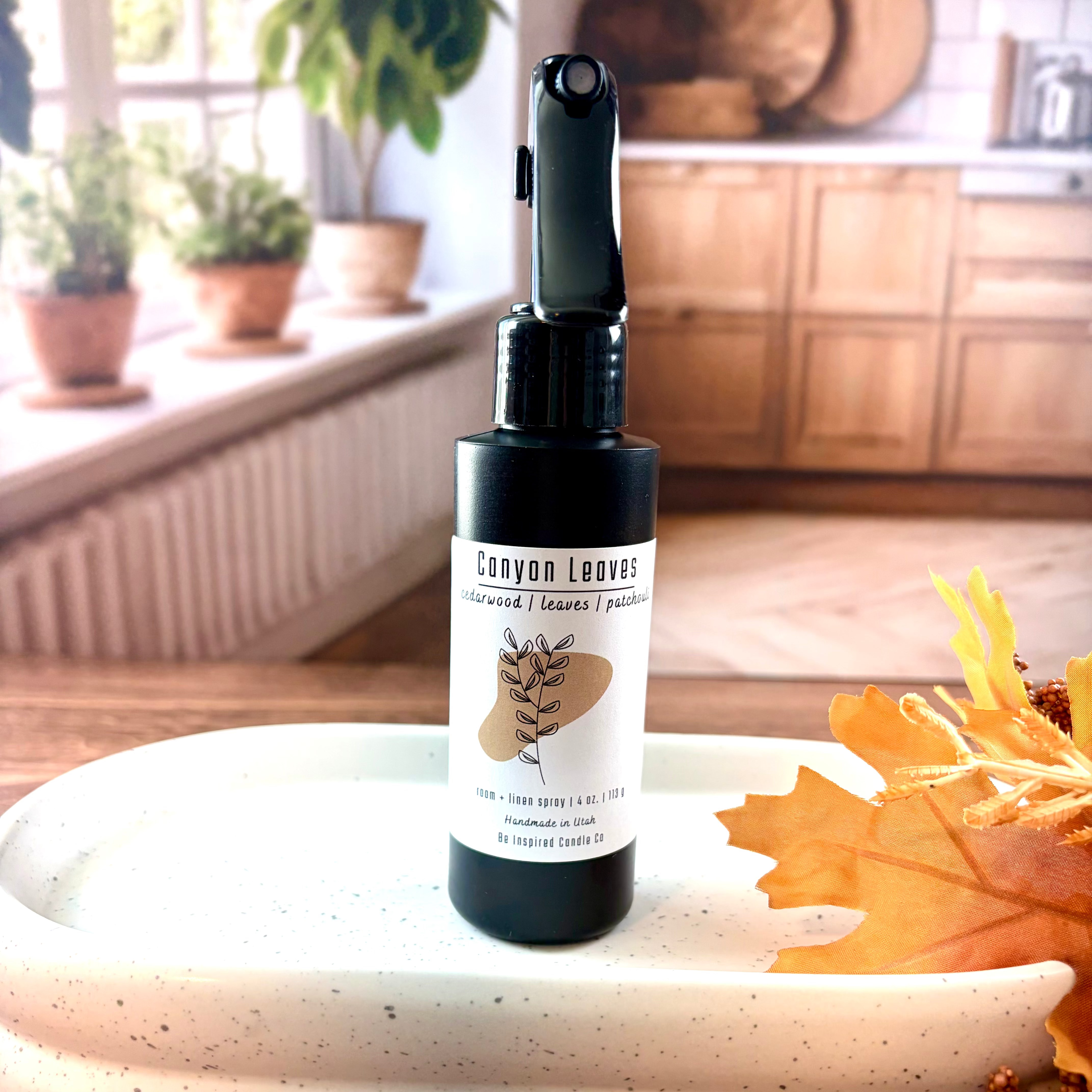 Black plastic spray bottle with a white label. 