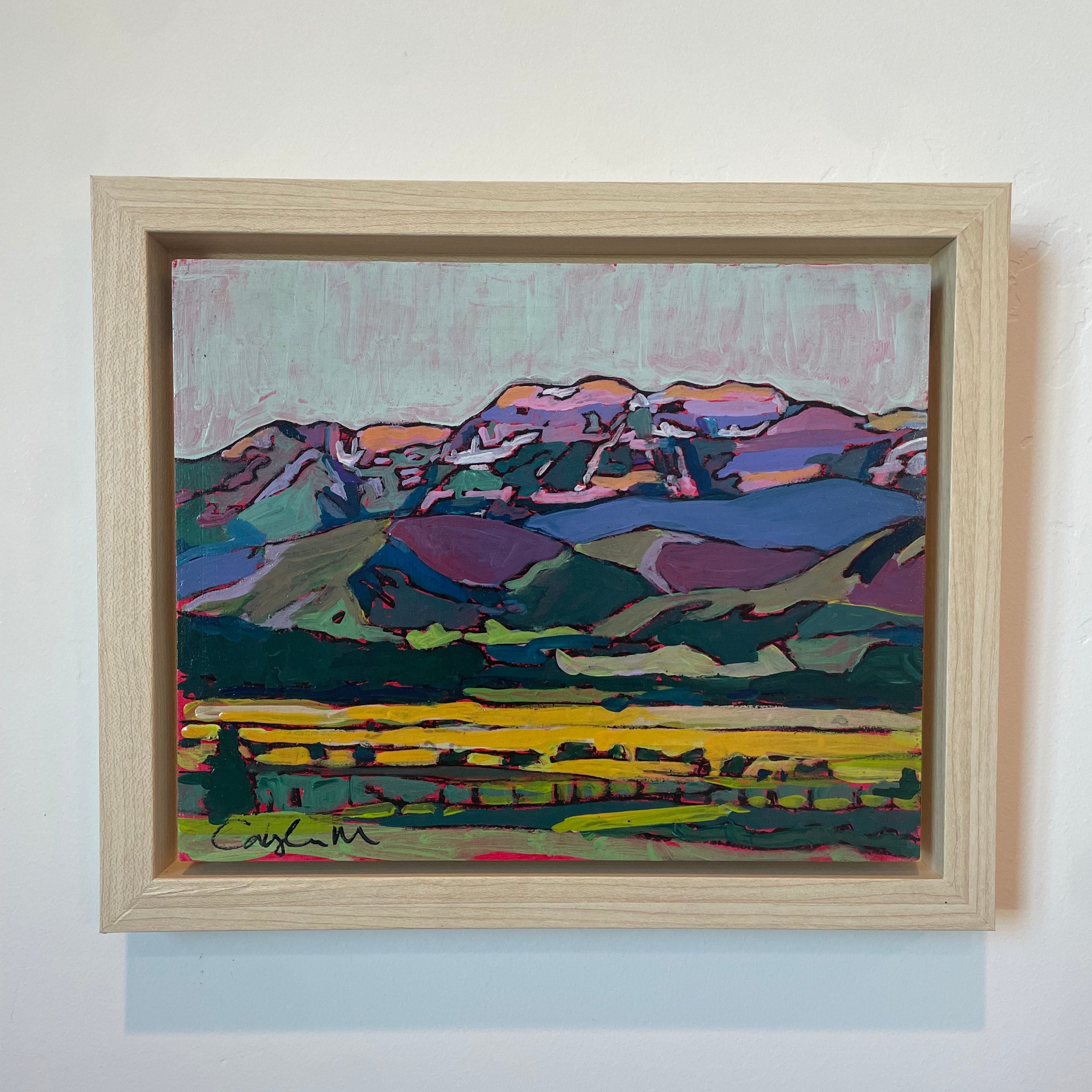 Bright hues of purple, orange, pink, blue, and green are used to show the landscape at dusk. The field in the foreground is bright yellow with leafy green trees scattered and a wooden fence making it's way to the edge of the painting. The sky is blue and purple. 