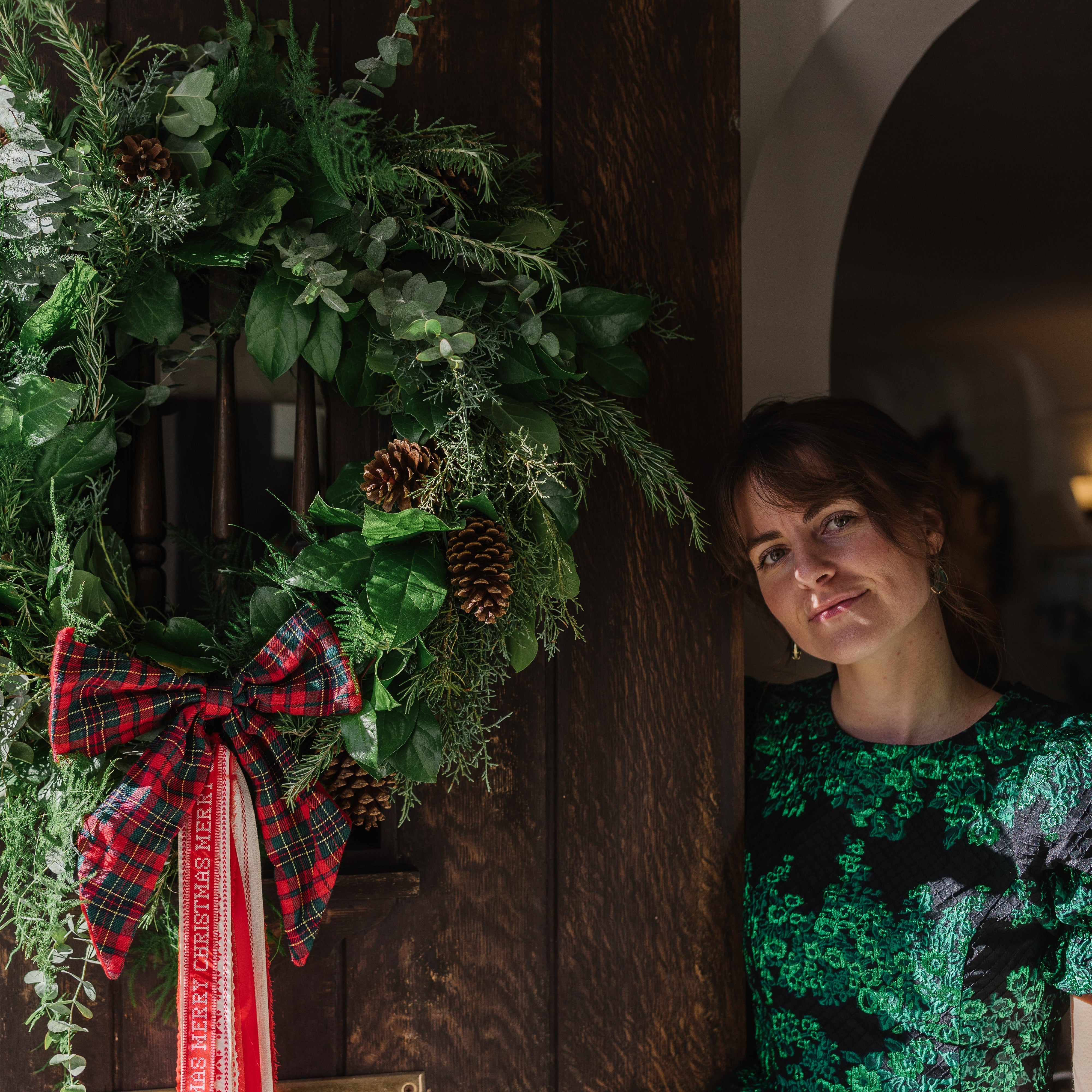 Welcome the holiday season with a fresh (and customizable) wreath by our local florist, Taylor Rae Bouquet. Hand-made with lush holiday greens, this fragrant wreath adds a touch of festive nature to any space.

This can be customized to your style by adding on draping ribbon and/or natural adornments like pinecones and dried oranges. All adornments and ribbon used are either homemade, local or second-hand (which is Taylor’s favorite).