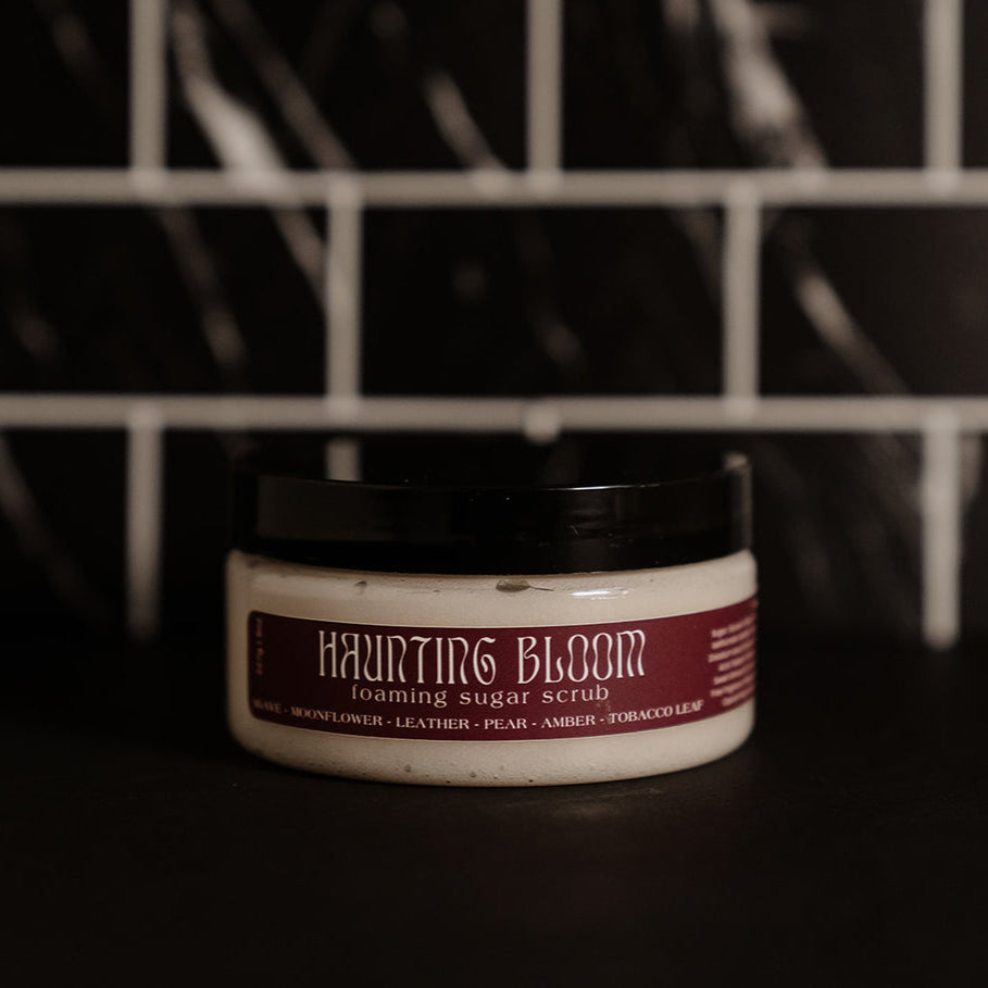 Small clear container with a black lid and burgundy label. Pictured against a black marble back splash.