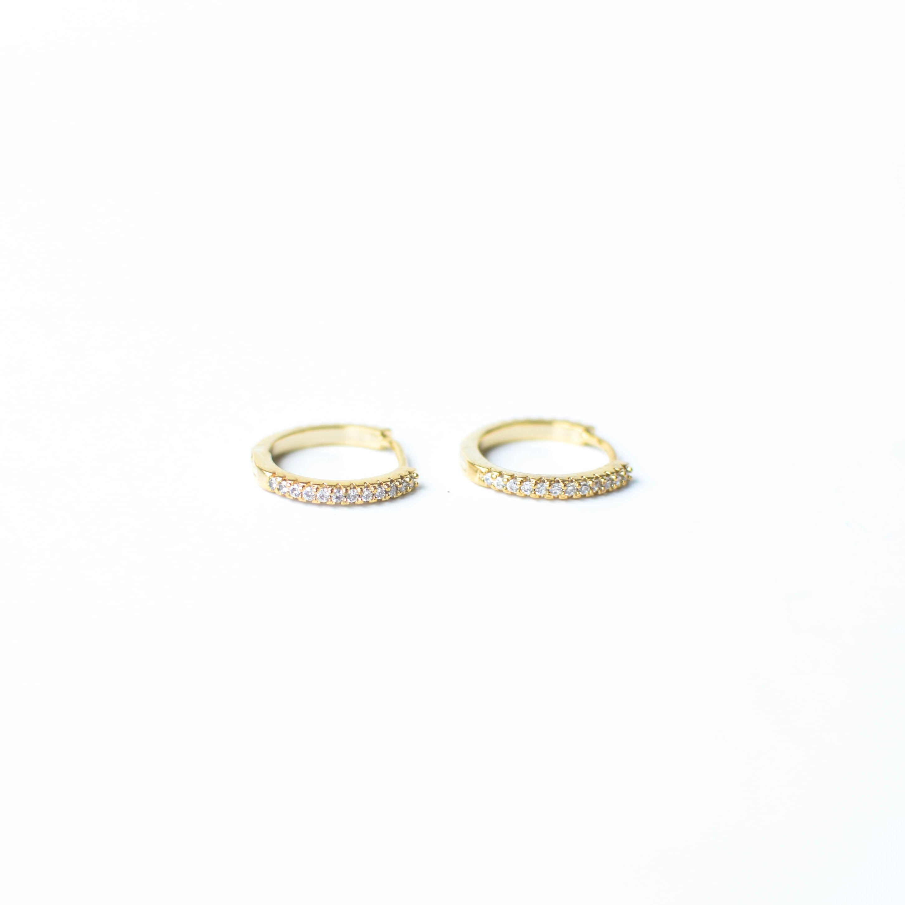 Our gold diamond huggies have been our bestselling earring for over a year, and it's no wonder.&nbsp; With a stunning and classic design, these earrings go with EV. ERY. THING.&nbsp; They are both timeless and on trend.&nbsp; Their&nbsp;unique click in click out clasp&nbsp;allows you to&nbsp;leave them in day and night without any discomfort.&nbsp;