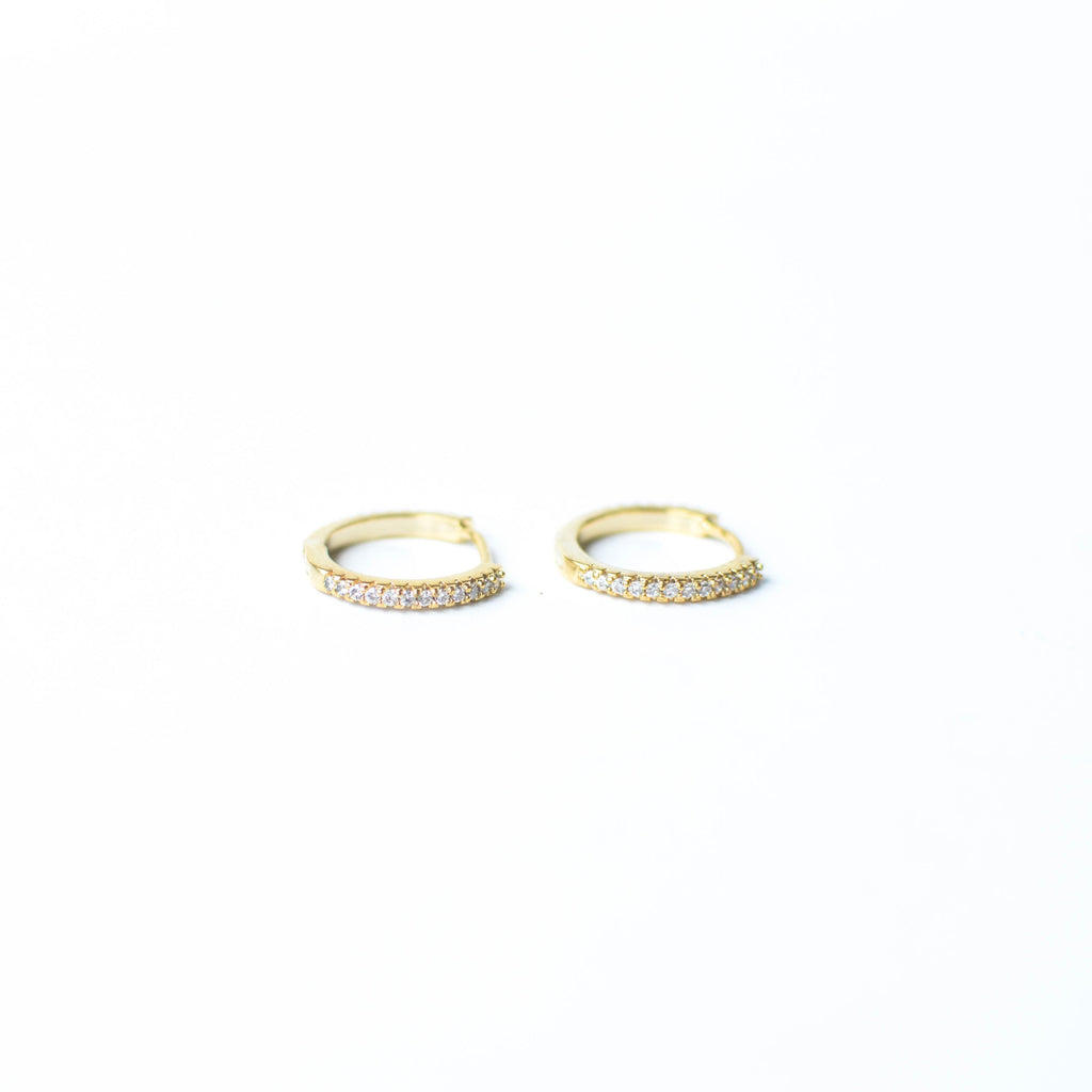Our gold diamond huggies have been our bestselling earring for over a year, and it's no wonder.&nbsp; With a stunning and classic design, these earrings go with EV. ERY. THING.&nbsp; They are both timeless and on trend.&nbsp; Their&nbsp;unique click in click out clasp&nbsp;allows you to&nbsp;leave them in day and night without any discomfort.&nbsp;