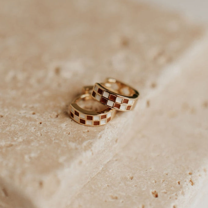gold huggies featuring a brown and white checkered pattern