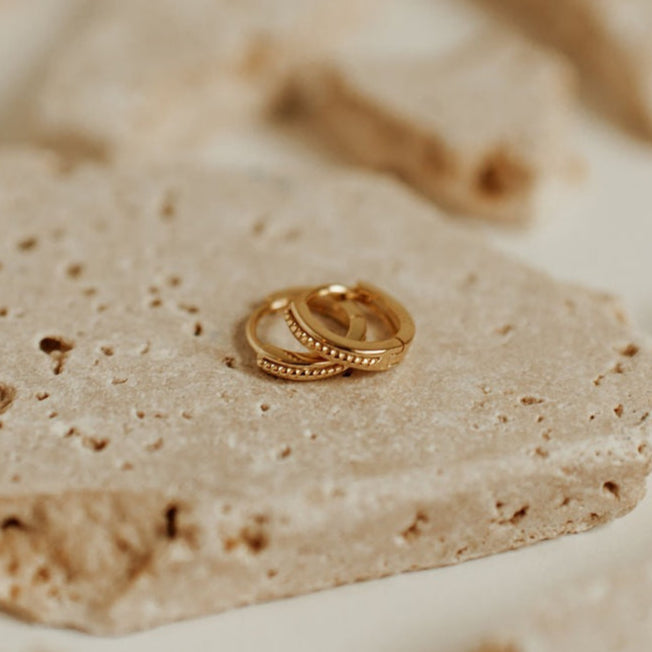 gold hoops with a twisted rope pattern