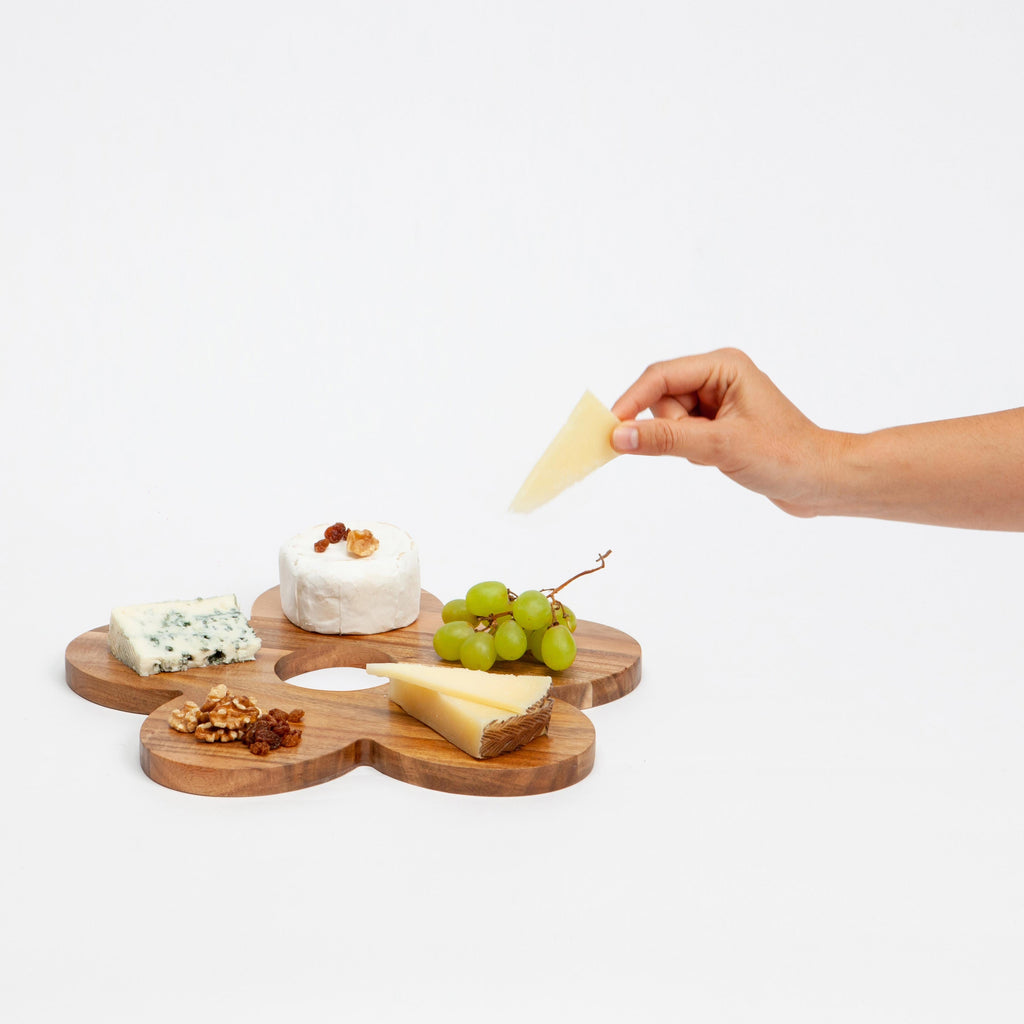 Serve up some flower power with the Daisy Serving Board! This playful and quirky board is perfect for serving snacks and treats. The beautiful daisy design adds a touch of whimsy to any gathering. Made from high-quality wood, it's durable and stylish. Bring some fun to your next party with the Daisy Serving Board.