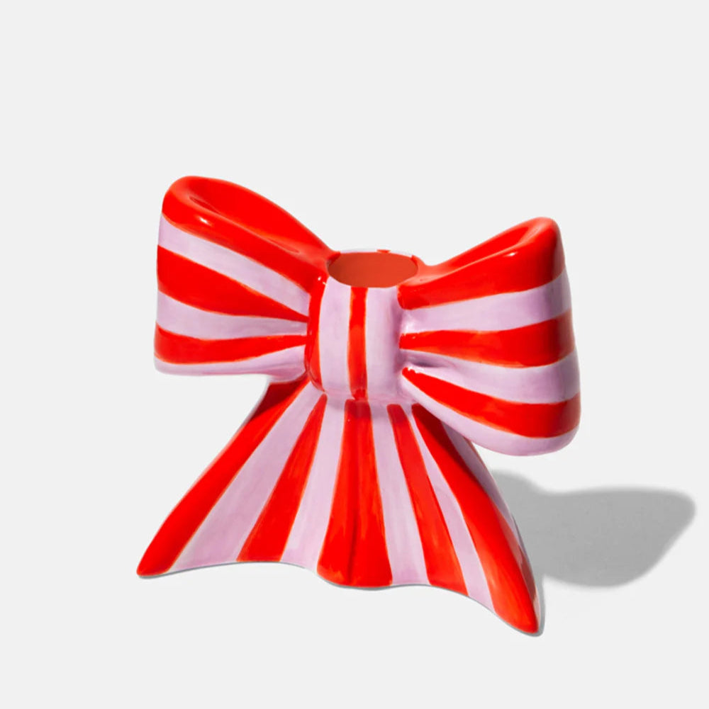 Ceramic candle holder shaped as a bow, taking inspiration from the ethereal ballet world and the whimsical allure of coquetry. 