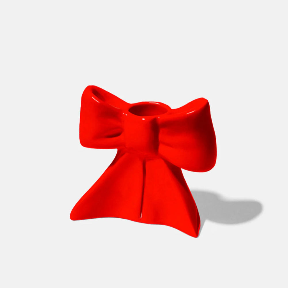 Ceramic candle holder shaped as a bow, taking inspiration from the ethereal ballet world and the whimsical allure of coquetry. 