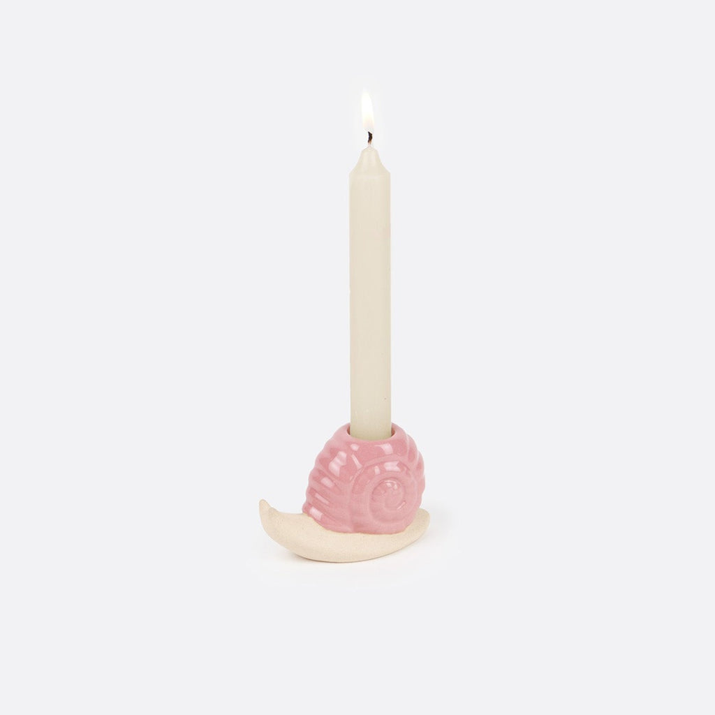 Add a touch of whimsy to your home with our Pink Snail Candle Holder! This quirky accessory will hold your favorite candles in style, while adding a playful element to any room. No need to take yourself too seriously - embrace the fun and charm of this unique decor piece.