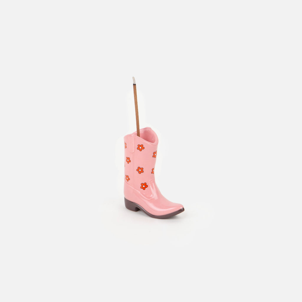 Saddle up for a fragrant journey with our Pink Cowboy Boot Incense Holder! This boot-shaped holder is perfect for holding your favorite incense sticks, adding a touch of fun to your home decor. So kick back, relax, and let the scents of the wild west fill your space!