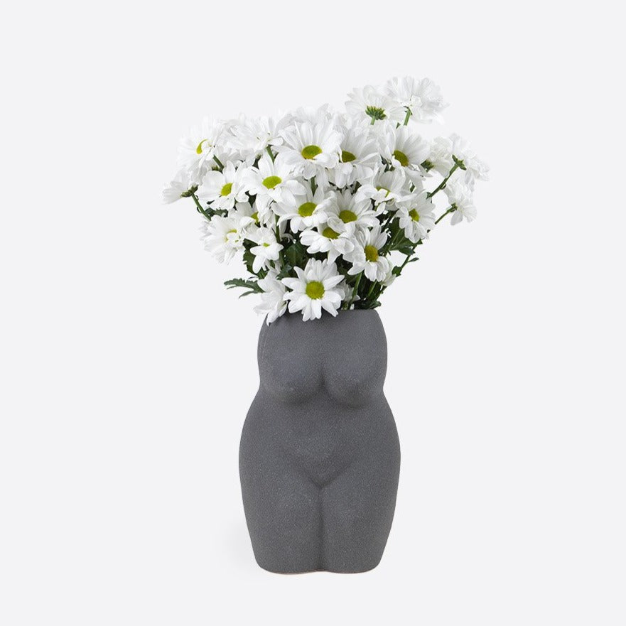 This ceramic vase adds a touch of whimsy to any room. Its playful shape and unique design will bring life to your space. Perfect for displaying your favorite flowers or as a standalone piece of art. Get creative with the versatile Ceramic Vase!