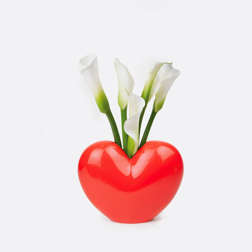 "Fall in love with your decor with our Red Heart Ceramic Vase. This quirky, playful vase is the perfect addition for adding a touch of love and personality to any room. Its red heart design and ceramic material make it a unique and charming piece."