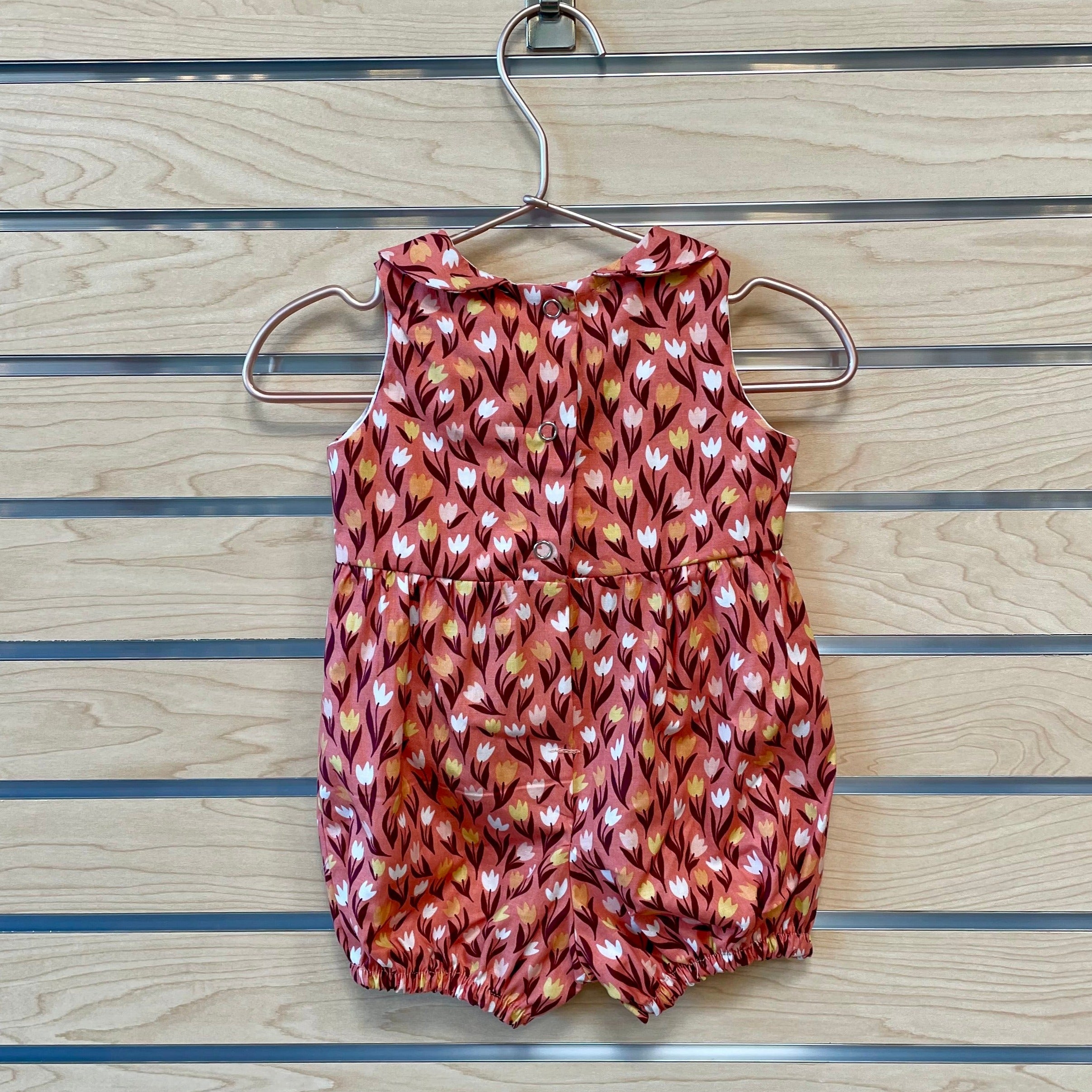 Welcome the warmer season with The Harper Romper - Pink Tulips! Featuring a beautiful pink tulip pattern, this romper will make your little one the most stylish kid on the block! With its comfortable fabric and adjustable straps, they'll be able to "romp" around in style and stay cool even on the hottest days! The perfect addition to your adorable baby’s wardrobe!