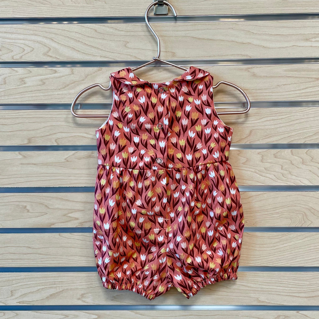 Welcome the warmer season with The Harper Romper - Pink Tulips! Featuring a beautiful pink tulip pattern, this romper will make your little one the most stylish kid on the block! With its comfortable fabric and adjustable straps, they'll be able to "romp" around in style and stay cool even on the hottest days! The perfect addition to your adorable baby’s wardrobe!