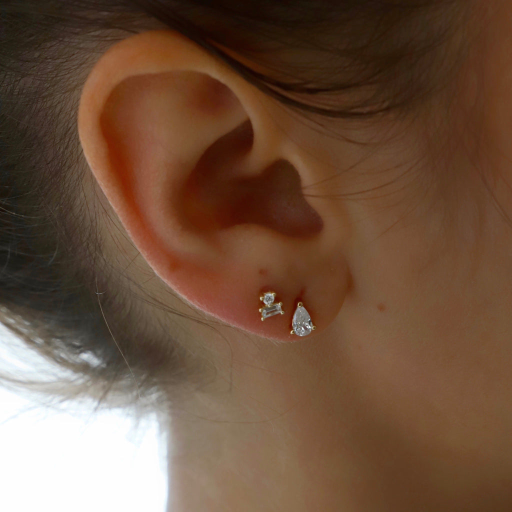 Add a touch of whimsy to your jewelry collection with our Miniature Teardrop CZ Studs! These charming earrings feature delicate teardrop-shaped stones that will add a subtle sparkle to any outfit. The perfect accessory for both casual and formal occasions, these studs are a must-have for any stylish and fun-loving individual!