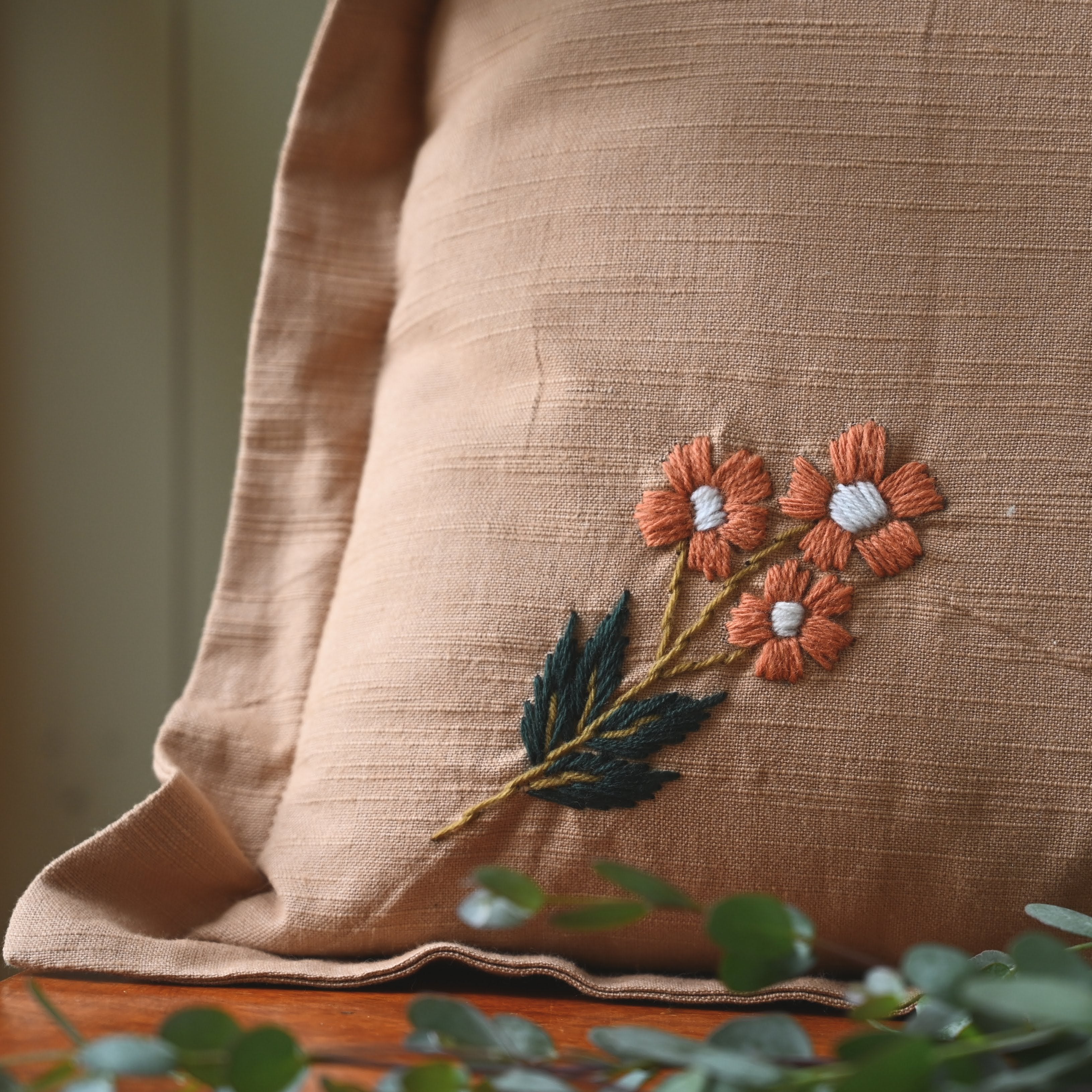 This beautiful, classic pattern features four embroidered flowers on our rose colored pillow. Our Ada Clare pillow features wool thread embroidery and each flower has been hand sewn to make this pillow truly one-of-a-kind.
