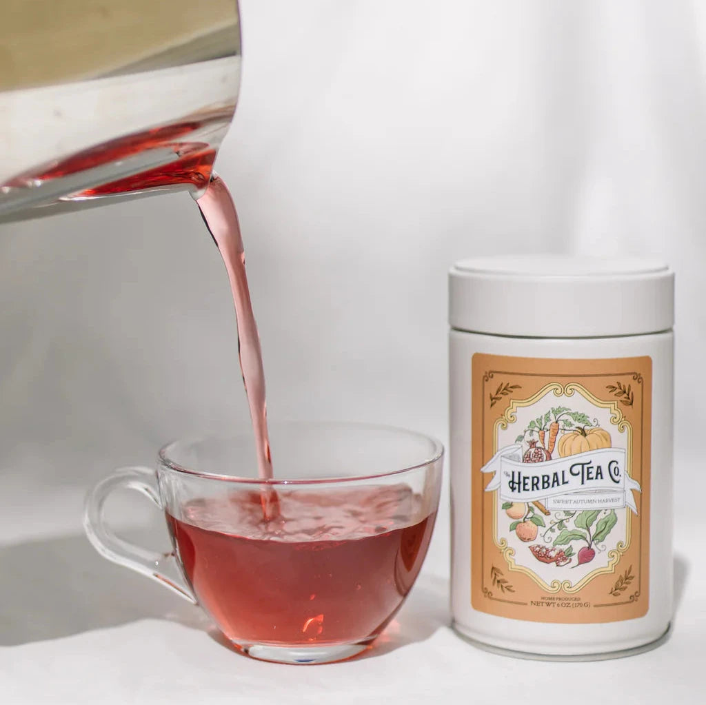 Sweet Autumn Harvest tea tin and clear teacup full of brewed tea