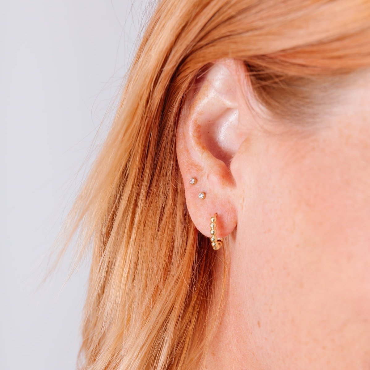 With a light and fun design, these bubble huggies have everything you love about huggies mixed with a new, playful style that makes them essential all day wear. These earrings go with EV. ERY. THING.  They are both timeless and on trend.  Their unique click in click out clasp allows you to leave them in day and night without any discomfort. 