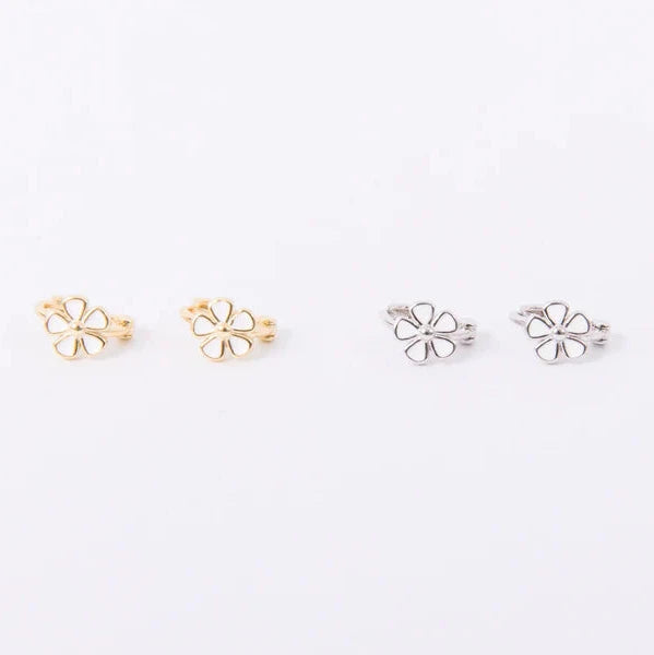Inset daisy with unique texturing and five tiny enamel petals. Gold and silver huggie hoops