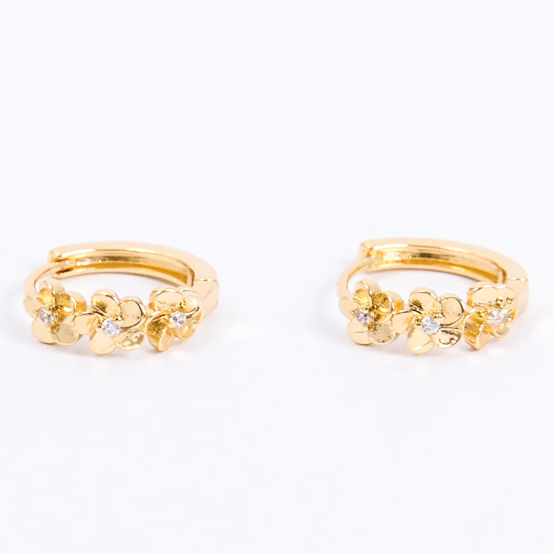 A pair of small gold hoop earrings featuring three-dimensional floral designs with tiny sparkling stones at the center of each flower. The earrings have a polished, elegant finish, combining simplicity with a delicate, nature-inspired detai