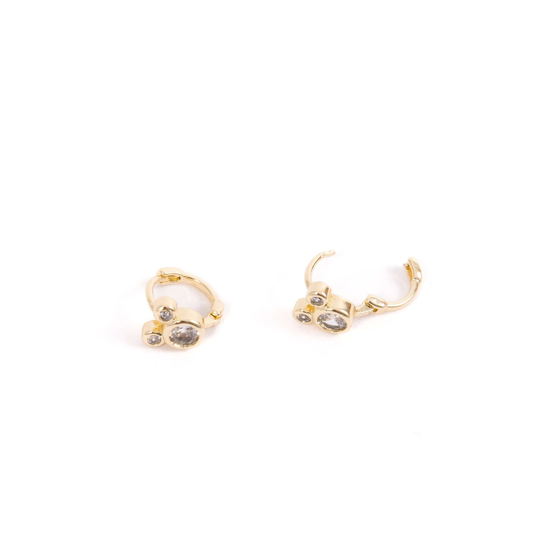 Mouse ear huggies lying on their side, one is open, showing the hinge clasp. 