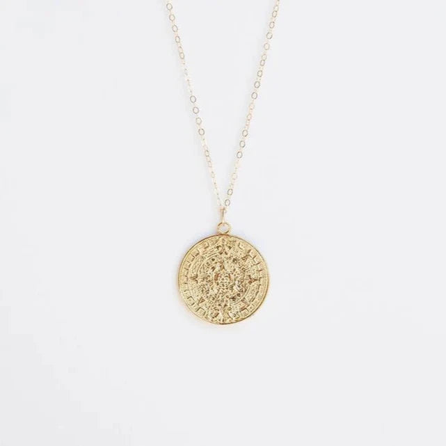 14k gold plated charm over brass.
14k Gold Filled Chain
14k Gold Filled wiring, jump rings, and clasp
Available in 18 inch or 20 inch.&nbsp; (18 inch is our standard necklace length)
Large Kya charm is 1” in diameter
Aztec Calendar Charm