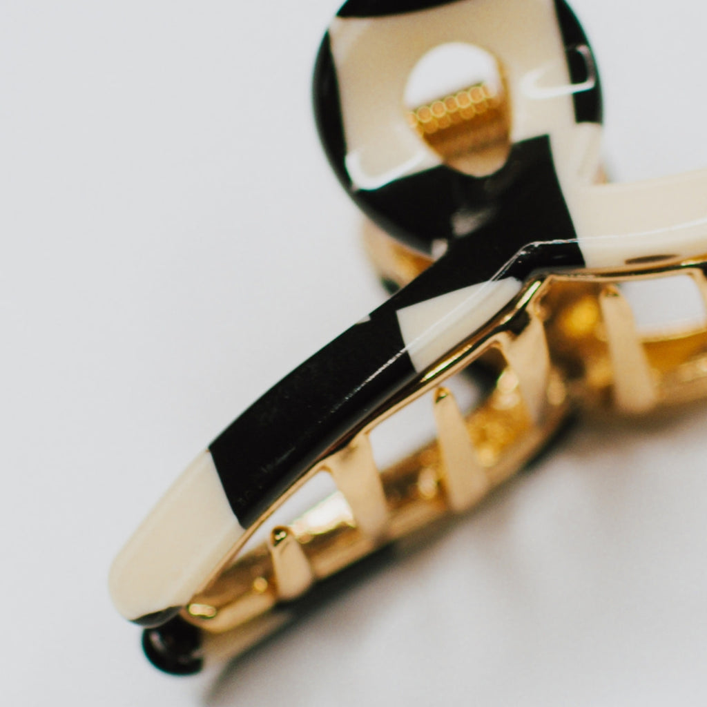 This pack includes two trendy pieces, a black checker and a spotted cream &amp; black hair claw, both made from high-quality acetate. These hair accessories are designed to add a touch of retro flair to your look while holding your hair tightly in place. Whether you're going for a casual or formal look, these Tiny Gold Loops will be your new best friend!