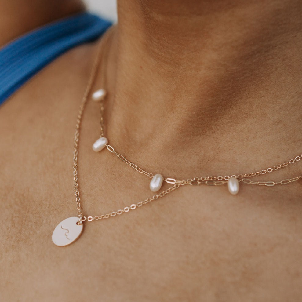 The Adelaide Pearl Necklace combines the best of two jewelry staples: a classic pearl necklace with our best selling paperclip chain. With these two styles of necklaces combined, we know you'll love this necklace that has the best of everything!
