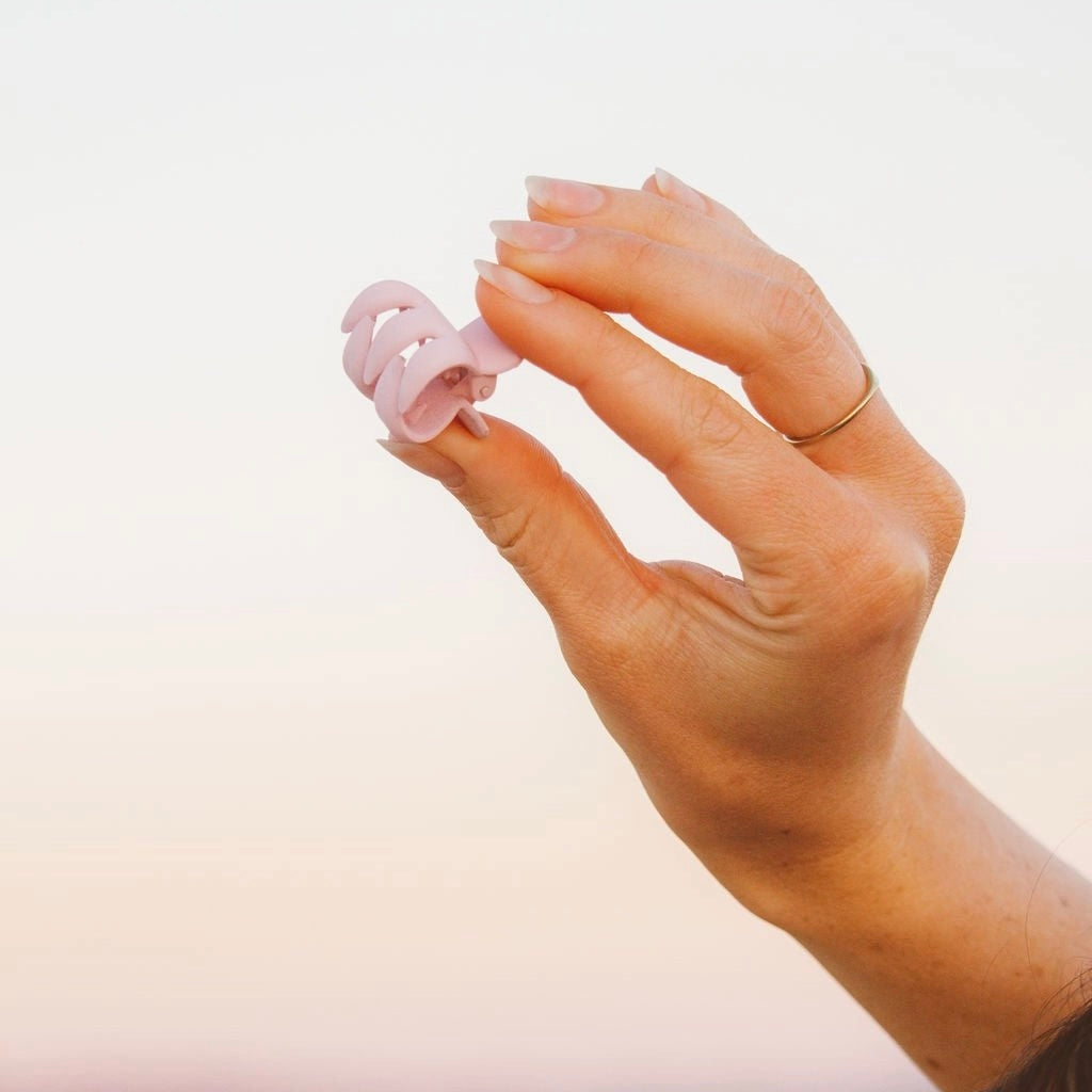 Secure your hair with ease using our Petite Claw Clip in Blush. This mini 1 inch clip features a beautiful blush pink color with a matte finish, perfect for everyday wear. Its simple design is perfect for adding a touch of style to any hairdo.