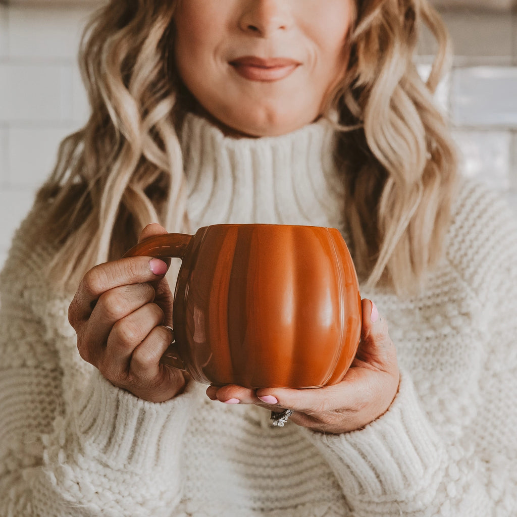 Sip your brew in style with this playful Orange Pumpkin Coffee Mug. With its bright orange hue and cozy design, it's the perfect mug to add a fall touch to your morning routine. Say goodbye to boring coffee mugs and hello to a pop of color and fun!