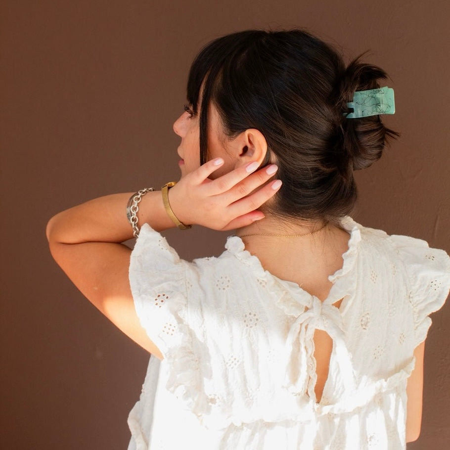 Secure your ponytail flawlessly with our Splatter Ponytail Claw Clip in a chic green color. The unique splattered design adds an unexpected twist to any French twist or slick backed ponytail. Say goodbye to slipping hair-do’s and hello to style with this playful clip!