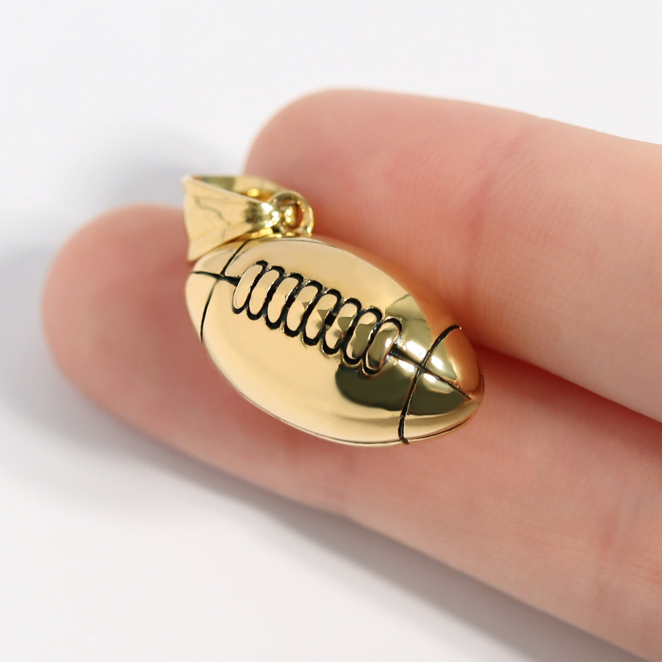 Bring a touch of sophistication to the world of sports jewelry with our 18K Gold PVD 3D Football Pendant. This expertly crafted pendant features a detailed, three-dimensional design of a classic football, symbolizing the passion and excitement of the game. Made with our proprietary blend of surgical-grade 18K Gold PVD coated stainless steel designed for everyday wear that you or a loved one can cherish for years to come!
