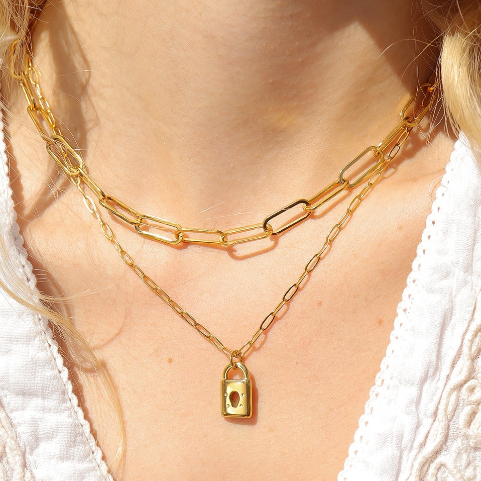 Our 18K Gold PVD Coated Stainless Steel Padlock Charm is the perfect fusion of durability, luxury, and modern design. The padlock charm is a strong, symbolic piece often associated with love, security, and commitment, making it an ideal choice for customers seeking meaningful jewelry. Its sleek, modern design comes in both a gold and stainless steel color.