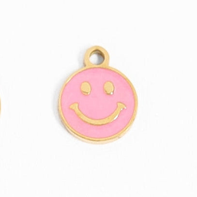 Add a pop of personality with this 18K gold smiley face charm in playful pink. Express yourself with this quirky accessory that will surely make you stand out. (Warning: potential side effect of making others smile uncontrollably.)