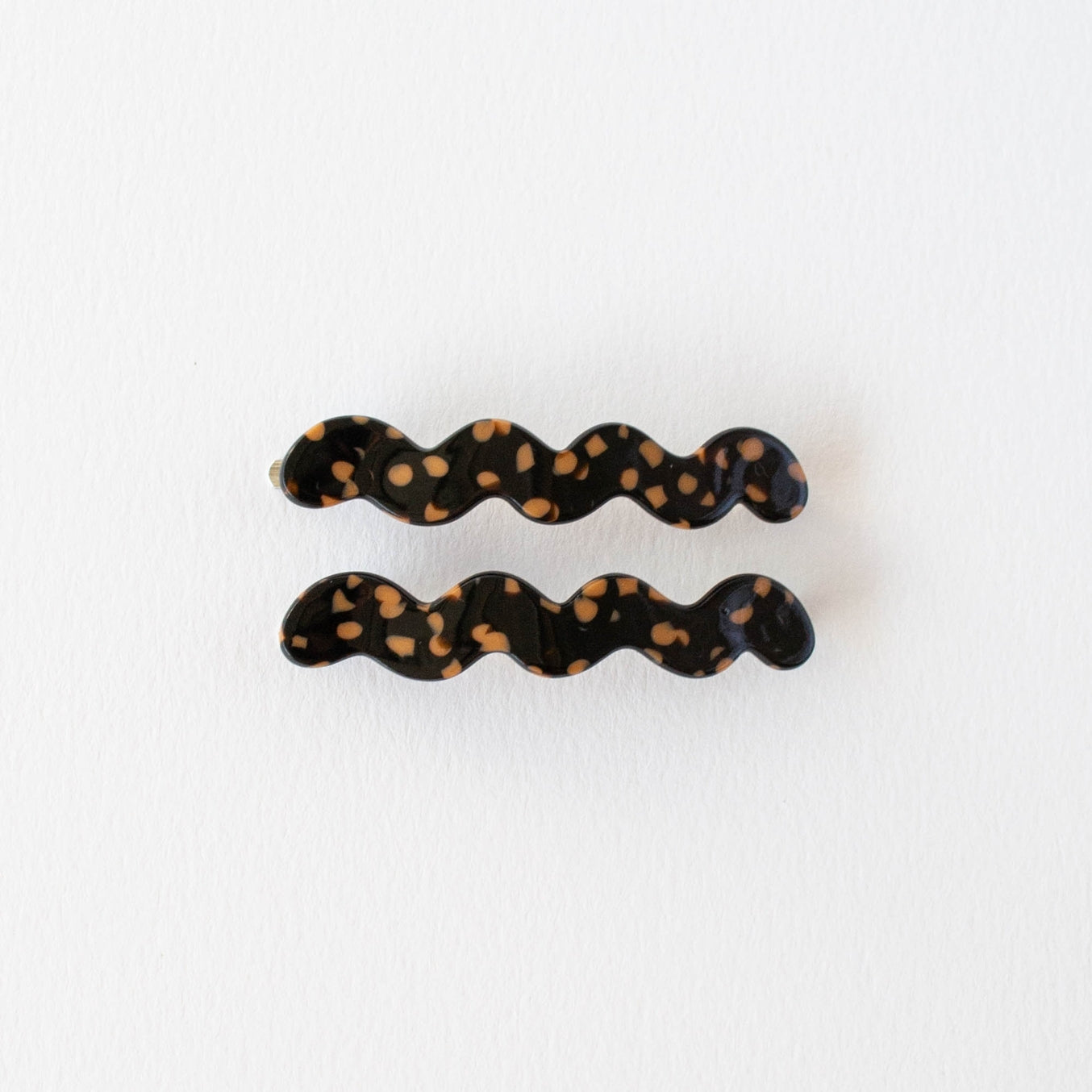 Experience effortless styling with the Eco Cloud Wave Slide Hair Pin Set. Crafted from eco-friendly materials, this set includes 2 unique cloud-wave slide hair pins that let you customize your look. With their easy slide-in design, keep your hairstyles looking as fresh as ever without damaging your locks. Set of 2.