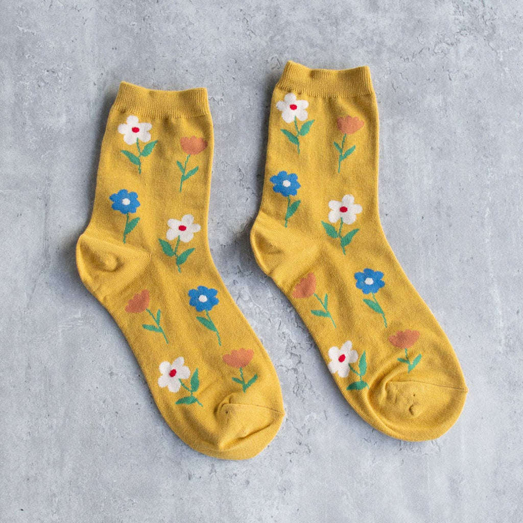Bloom into style with our Favorite Flower Socks! These adult socks feature a dainty flower pattern in a fun mustard yellow color. Spread some joy and flower power on your feet with these quirky and playful socks. (Socks may cause spontaneous dancing and increased joy levels.)