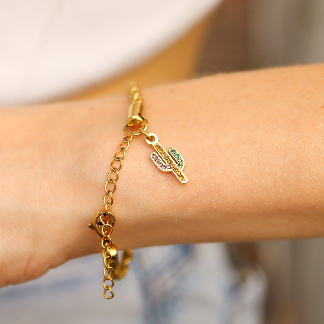Add a touch of quirkiness to your jewelry collection with our Cactus Cubic Zirconia Charm. This charm features a colorful cactus design, perfect for adding a pop of color to any outfit. The cubic zirconia adds a touch of sparkle, making it a fun and playful addition to any jewelry piece.