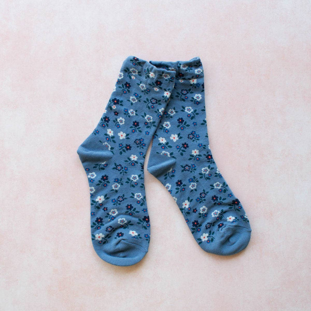 These Garden Flower Socks will add a touch of whimsy to your outfit with their blue floral pattern. Made in a comfortable crew style, these socks will keep your feet cozy and stylish all day long. Perfect for the nature-lover or fashion-forward individual!