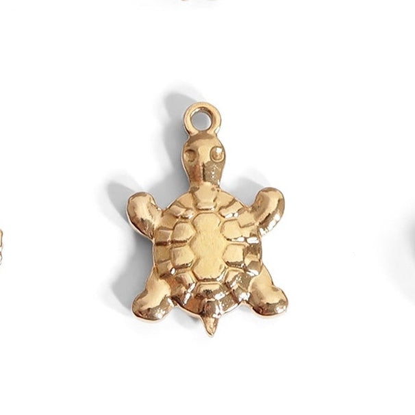 Add a touch of fun to your jewelry collection with our Gold Turtle Charm. This nautical-inspired charm features a vibrant gold color that will add a pop of personality to any outfit. Perfect for those who love a playful, beachy vibe!