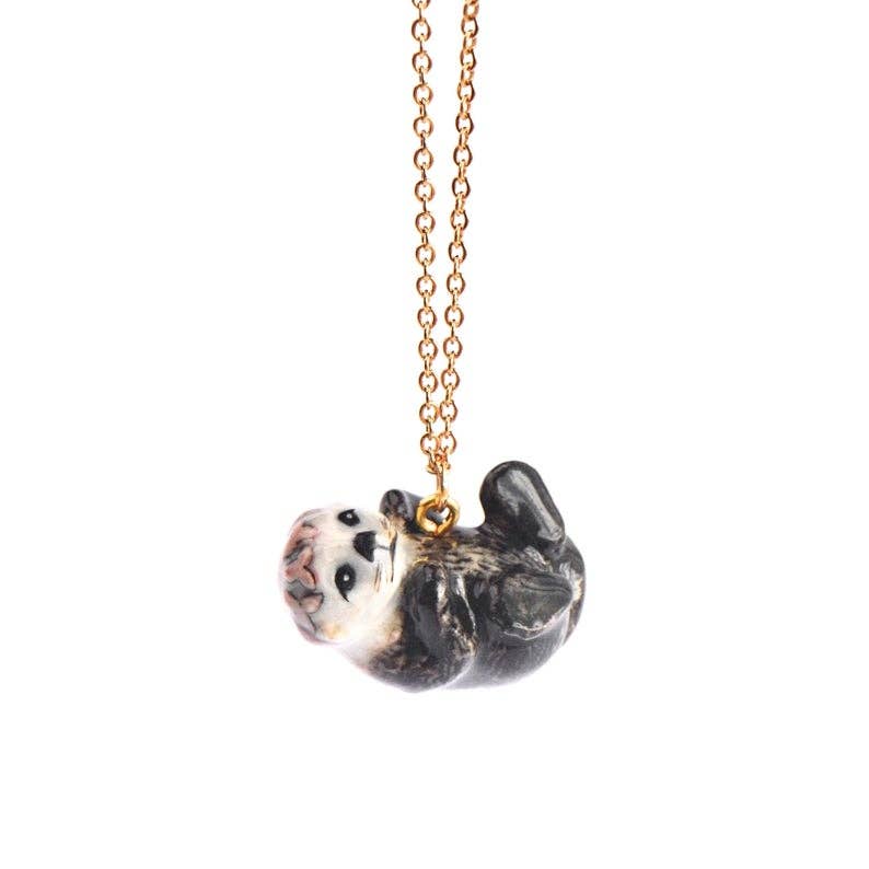 Embrace the joys of spring with our limited-edition  Baby Spring Otter Necklace! This handcrafted porcelain pendant features an adorable otter adorned with a vibrant floral crown, capturing the playful spirit of the season. Strung on a delicate chain, this necklace is a versatile and uplifting addition to any wardrobe. Due to the handmade nature of this product, slight variations in color and design may occur, making each piece truly one-of-a-kind.