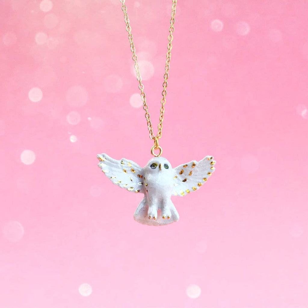 This Snowy Owl necklace is an heirloom piece! Hand-painted on porcelain with lovely gold details, this enchanting snowy white owl will add a touch of whimsy to any outfit. Perfect for nature lovers or anyone looking to add a quirky accessory to their collection. Due to the handmade nature of this product, slight variations in color and design may occur, making each piece truly one-of-a-kind.
