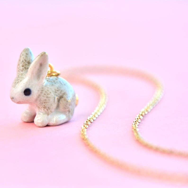 Meet Goldentail, the bunny that's hopping straight into hearts. This hand-painted porcelain pendant features an irresistibly cute bunny with a golden tail, capturing the essence of spring's renewal and joy. Due to the handmade nature of this product, slight variations in color and design may occur, making each piece truly one-of-a-kind. Ideal for animal lovers and those who appreciate the finer details, this pendant is a celebration of both nature and craftsmanship.