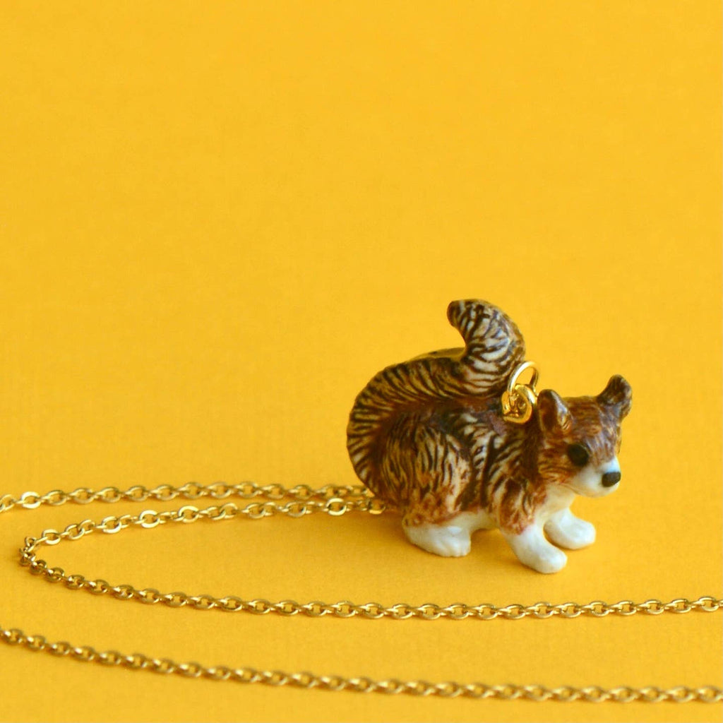 Embrace your playful side with our limited-edition Squirrel Necklace! This handcrafted porcelain pendant captures the squirrel's bright-eyed and bushy-tailed charm, adding a whimsical touch to any outfit. Strung on a delicate chain, this necklace is as versatile as it is adorable, effortlessly transitioning from casual daywear to elegant evening attire. Due to the handmade nature of this product, slight variations in color and design may occur, making each piece truly one-of-a-kind.