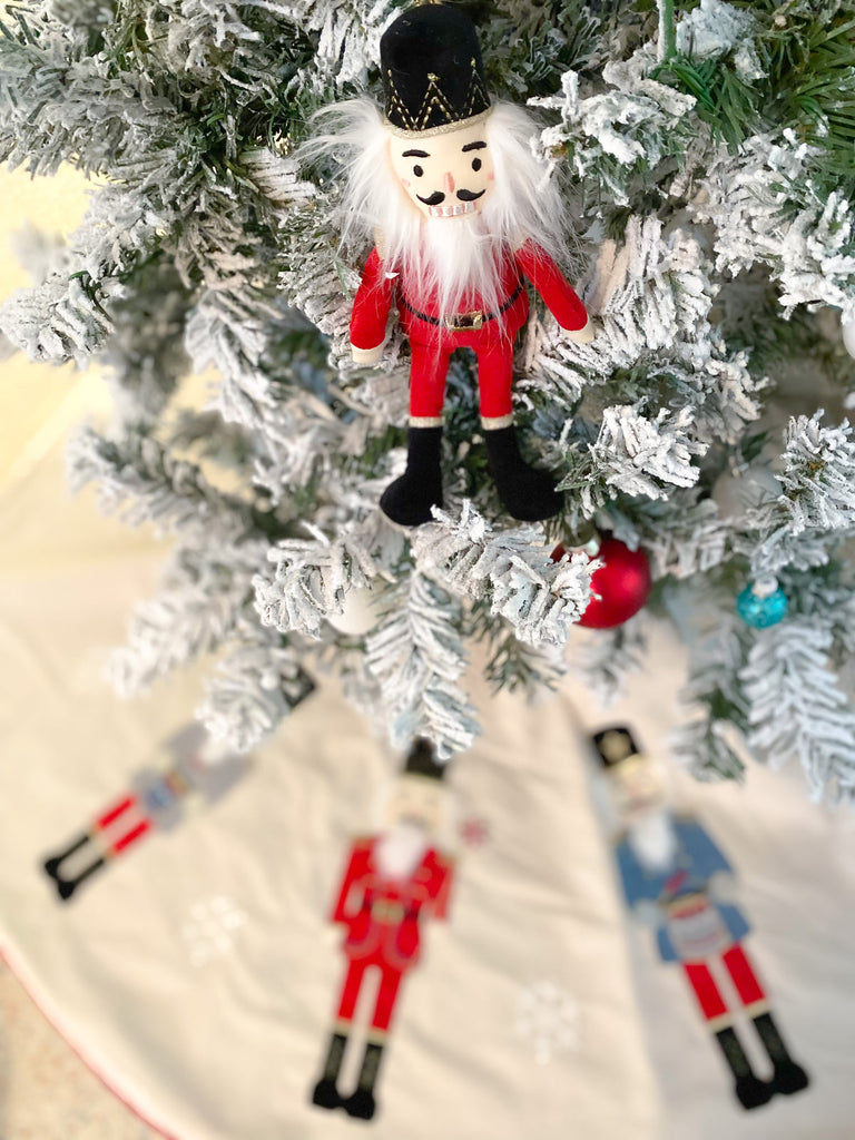 Hang on trees, wreaths and even chandeliers, our Nutcracker Plush Doll Ornament brings a new kind of whimsy to your seasonal decor.  Made of polyester and metallic thread. Measures 10" Each ornament is stitched with intricate embroidery, stitching and multiple fabrics and textures to bring these plush dolls to life. Hangs from a metallic loop. Spot clean only For decorative use only, not a toy