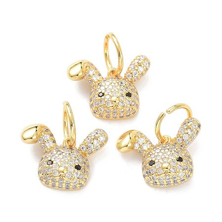 This bedazzled rabbit charm, made with sparkling cubic zirconia, is the perfect addition to your bracelet or necklace. Bring a touch of whimsy and sparkle to any outfit with this charming accessory. Perfect for rabbit lovers or anyone who loves unique and eye-catching pieces.
