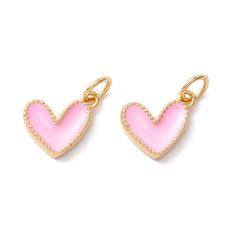 Accentuate your style with ourGold Edged Pink Heart. This adorable charm features a baby pink enamel heart with elegant gold edging, making it the perfect addition to your bracelet or necklace. Show your love and add a touch of sweetness to any outfit.