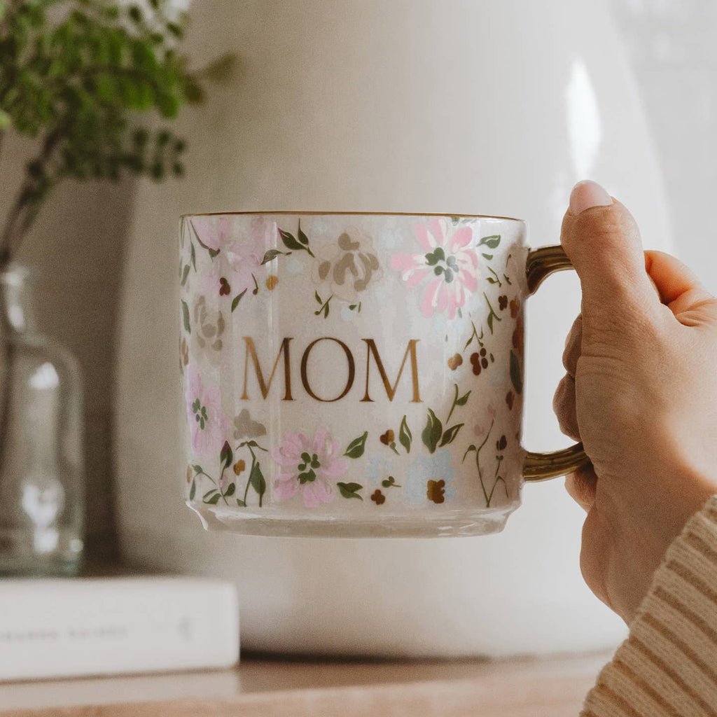 Show your mom some love with our Mom Pink Floral Coffee Mug. Featuring a soft floral design, gold handle, and the word "Mom" written on the front, this coffee mug is the perfect gift for Mother's Day or any special occasion. Enjoy your favorite hot beverage in style while showing appreciation for all that she does.
