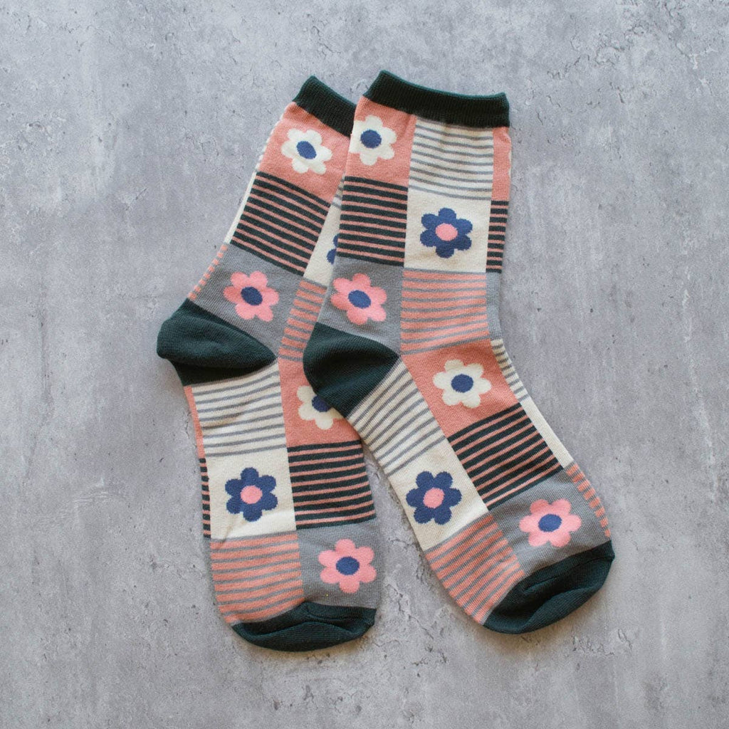 Step up your sock game with our Daisy Teal & Coral Multi Striped Socks. The perfect combination of style and comfort, these crew socks feature a playful daisy and striped design in fun teal and coral colors. Elevate any outfit with these fun and fashionable socks.