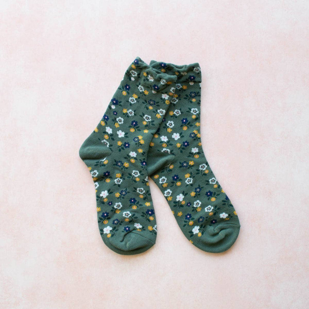 These Garden Flower Socks will add a touch of whimsy to your outfit with their green floral pattern. Made in a comfortable crew style, these socks will keep your feet cozy and stylish all day long. Perfect for the nature-lover or fashion-forward individual!