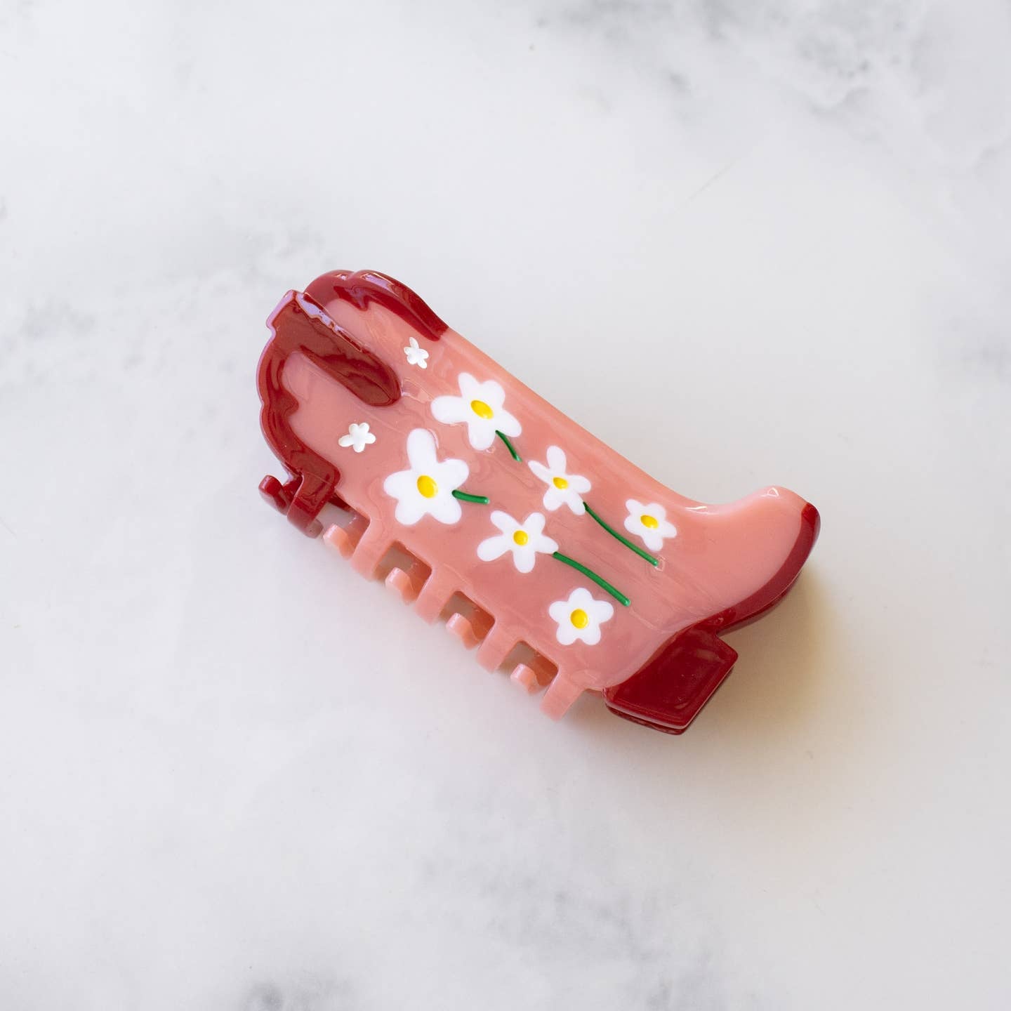 Eco Daisy Flower Cowboy Boots Hair Claw Clip, the perfect accessory for any Western-inspired outfit. Made with sustainable materials, this clip showcases beautiful daisy flowers and features a secure, easy-to-use grip. Upgrade your hair game with this eco-friendly and stylish clip.
