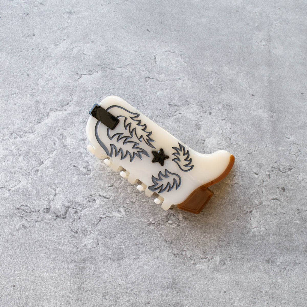 Western Boot Hair Claw Clip, the perfect accessory for any Western-inspired outfit. Made with sustainable materials, this clip showcases an intricate boot design and features a secure, easy-to-use grip. Upgrade your hair game with this eco-friendly and stylish clip.